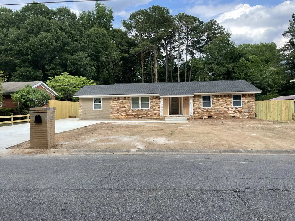 Single-story brick house with paved driveway.