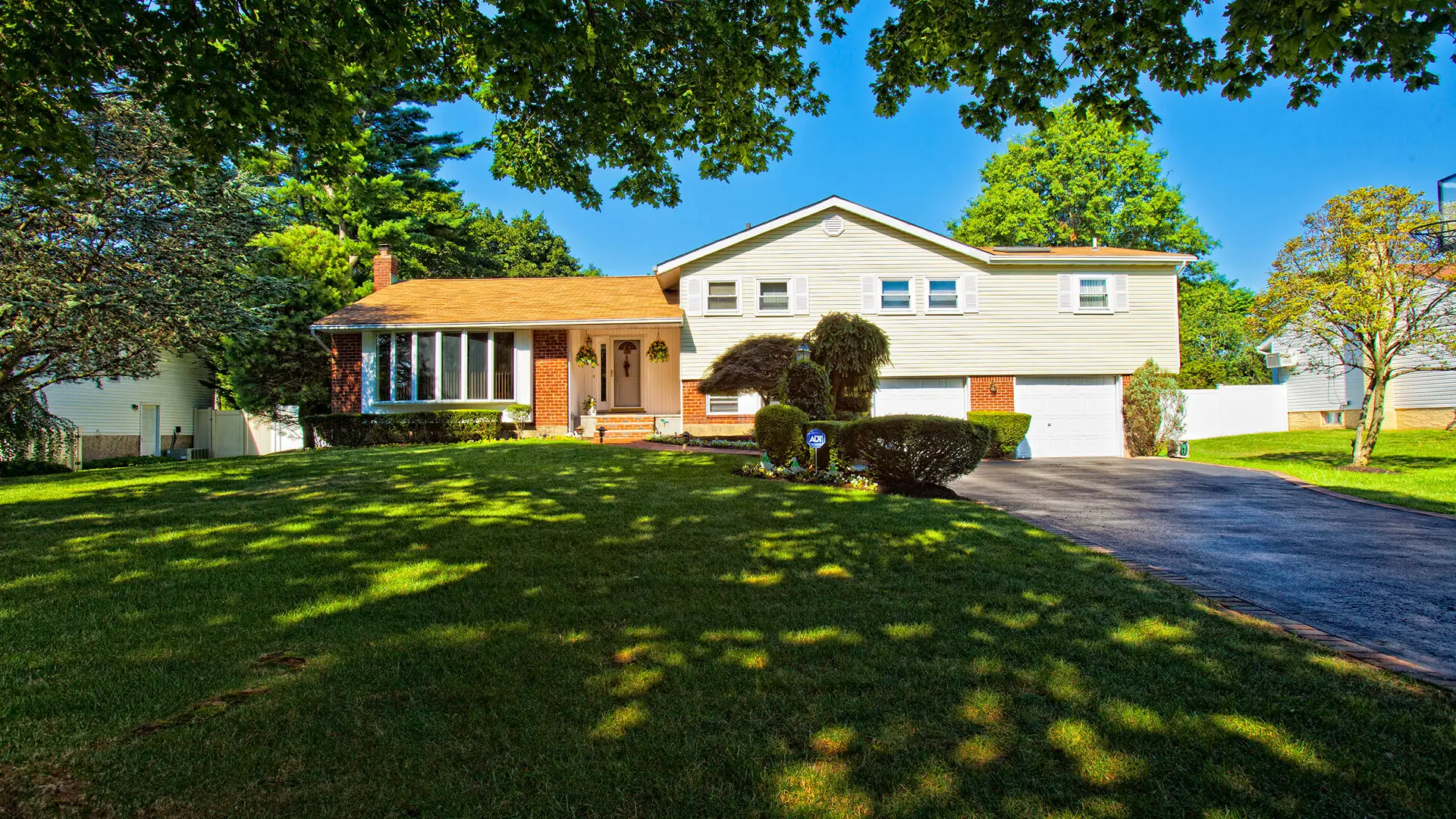Suburban house with large front lawn.
