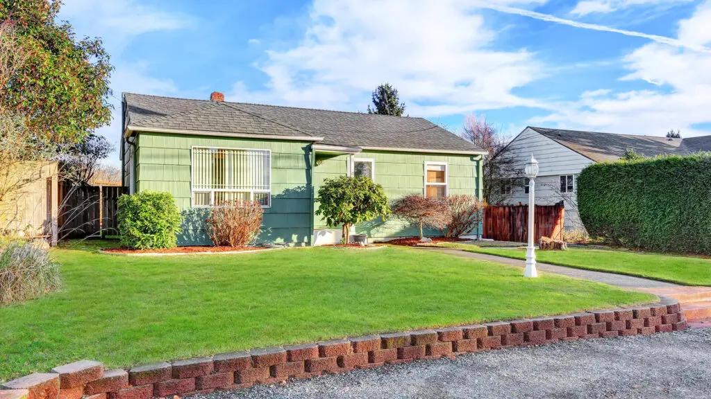 Small green house with front yard.