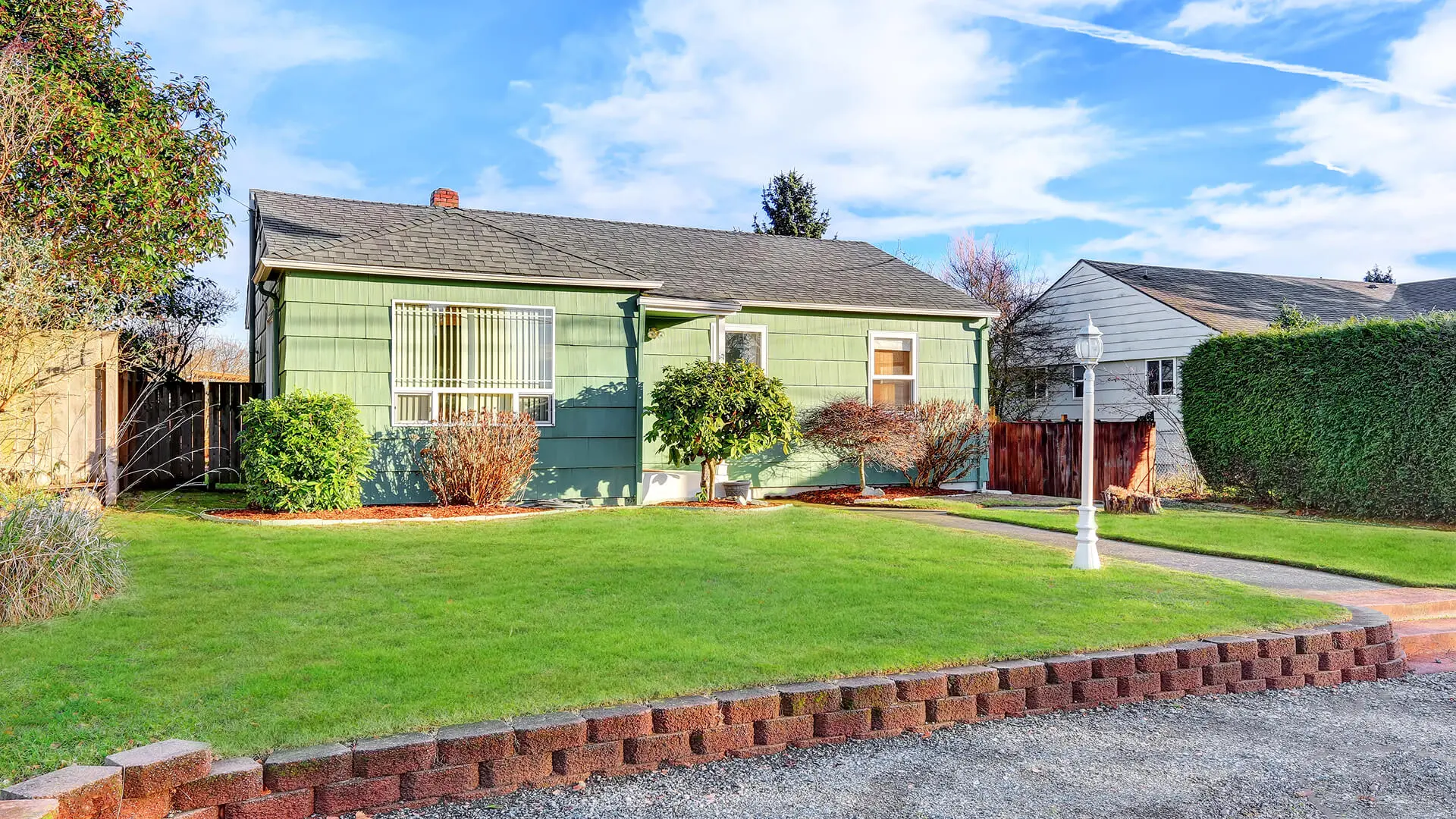 Small green house with front yard.