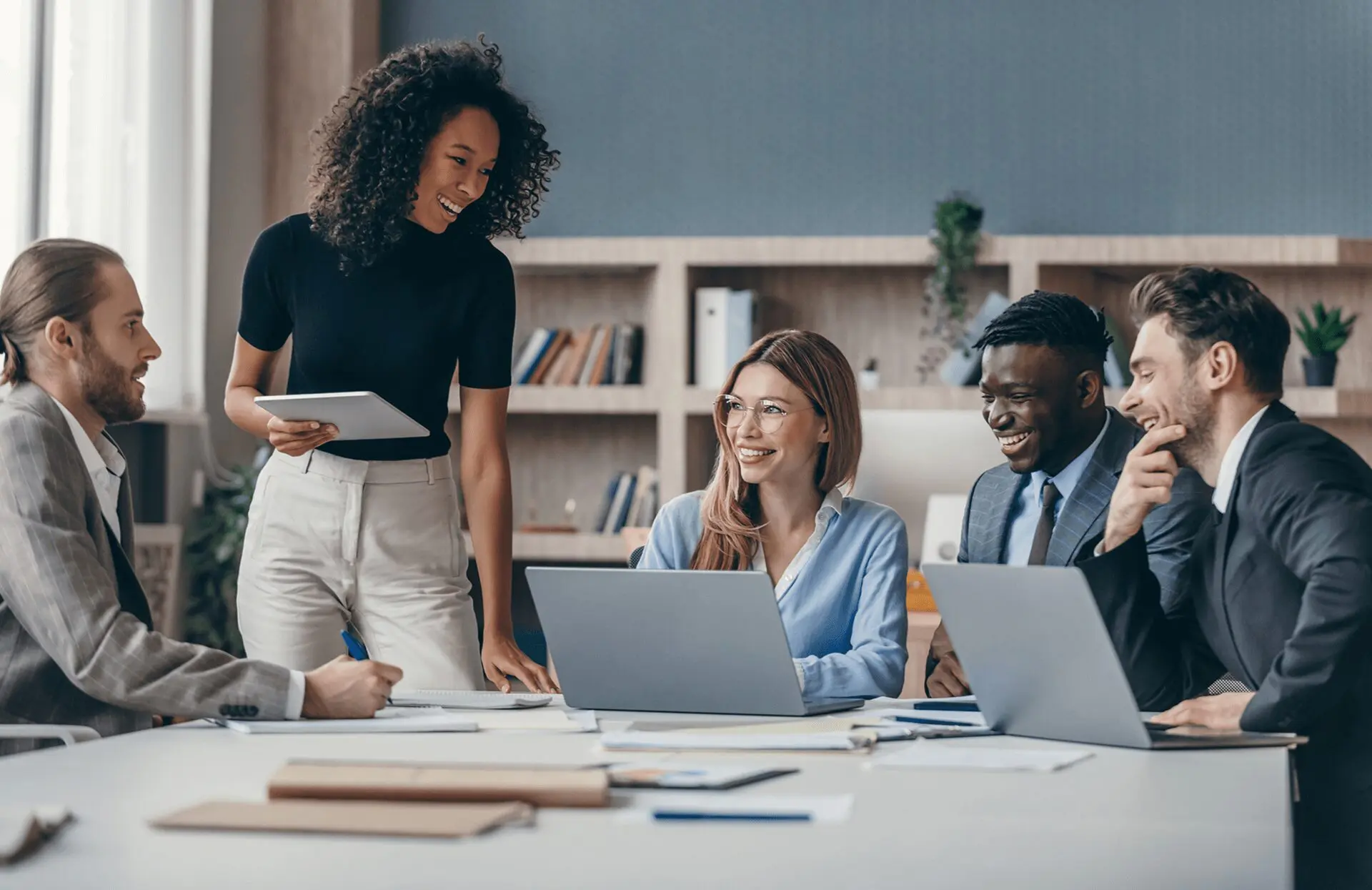 Colleagues smiling during a business meeting.