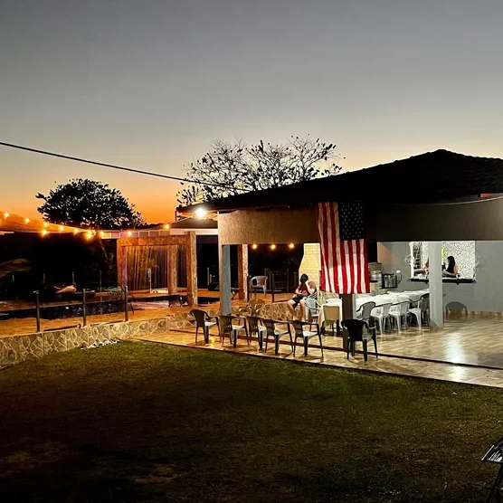 Outdoor patio with string lights at sunset.